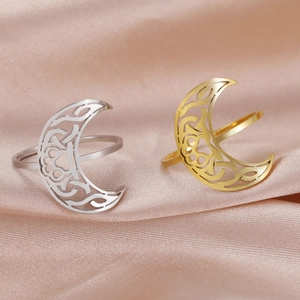Elegant hollowed moon cat paw rings in gold and silver finish on silk fabric