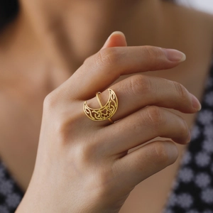 Elegant gold crescent moon open ring with hollow cat paw and celtic knot on finger