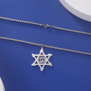 Détail macro du pendentif hexagramme en acier argenté avec l'œil de la providence gravé