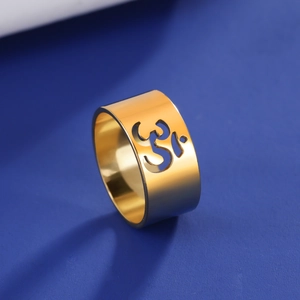 Detailed view of the hollow Om symbol on the polished gold stainless steel yoga ring