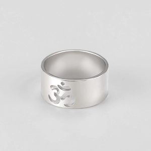 Macro shot of 9.8mm wide stainless steel ring with cutout Om symbol yoga design