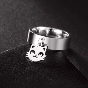 Polished stainless steel ring with a cute cat head charm on a black leather background