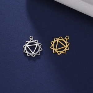 Mandala yoga pendants in gold and silver steel finishes on a dark blue surface