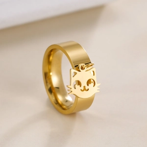 Golden stainless steel ring with a hanging cartoon cat head charm and polished finish