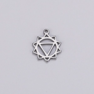 Macro view of silver stainless steel yoga pendant with geometric sunburst and triangle