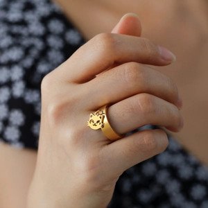 Chic gold titanium steel ring with a cute dangling cat charm and matte textured finish