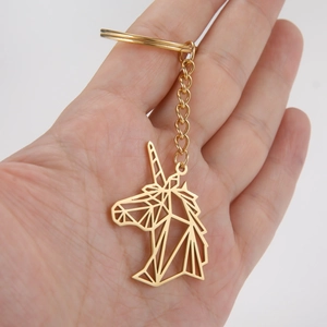 Detail of geometric unicorn keychain in polished gold-plated stainless steel material
