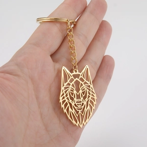 Detailed view of a golden geometric wolf head keychain with a sturdy metal ring and chain