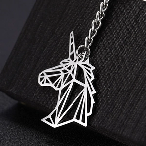 Macro shot of silver geometric unicorn keychain made of polished stainless steel