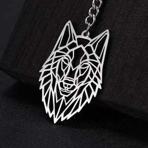 Macro shot of silver stainless steel wolf head keychain with hollow geometric design