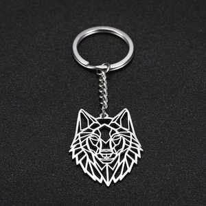 Close-up of a stainless steel keychain featuring a hollow geometric wolf head pendant