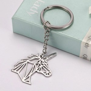 Macro detail of silver stainless steel unicorn keychain with geometric hollow design