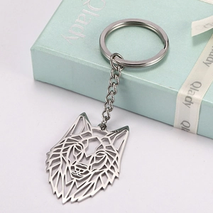 Hollow wolf head stainless steel keychain with silver finish on a blue gift box