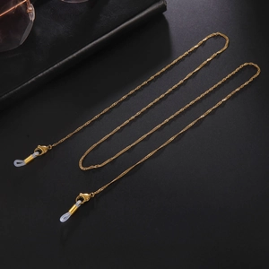 Detailed view of golden water wave chain with lobster clasps and silicone loops