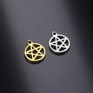 Macro detail of gold and silver pentagram star charms with a polished mirror finish
