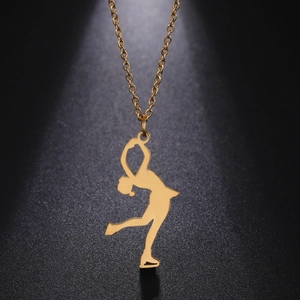 Detailed view of a golden figure skater pendant on a sleek stainless steel chain
