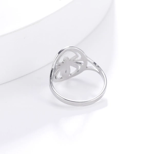 Macro shot of silver gothic spider ring featuring hollow carved eight legs on white stand