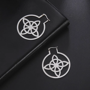Macro view of polished 304 stainless steel earrings featuring an intricate witch knot design