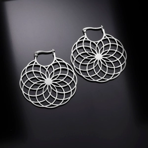 Detailed view of silver stainless steel mandala earrings with intricate hollow-out floral patterns