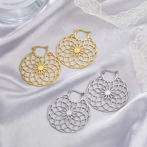 Chic hollow daisy geometric earrings in gold and silver finish on white silk background