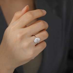 Minimalist silver stainless steel ring with laser-engraved pinky promise gesture