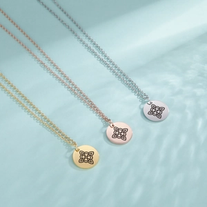 Three-color stainless steel necklaces with Celtic witch knots on a wavy blue background