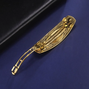 Golden Celtic knot vintage spring hair clip with embossed metal texture and secure back clasp