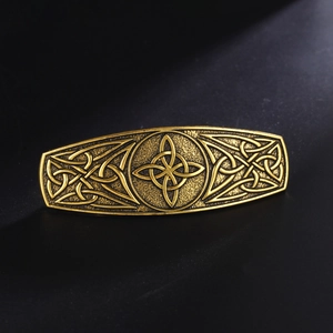 Detailed view of the vintage gold Celtic knot engraving on the long metal hair clip