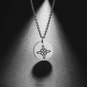 Polished stainless steel necklace featuring a Celtic knot pendant on an O-chain link