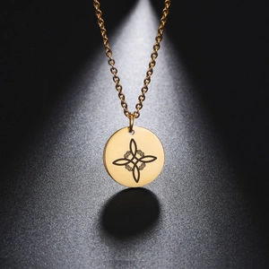 Detailed view of a gold circular Wicca knot pendant on a delicate chain necklace