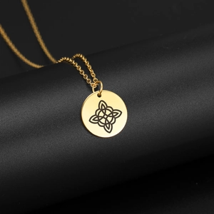 Macro shot of gold stainless steel necklace with laser-engraved Celtic witch knot pendant