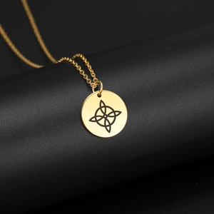 Detalle del collar de acero inoxidable dorado con colgante redondo de nudo celta negro