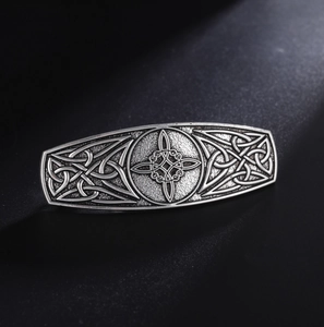 Macro shot of vintage silver celtic knot hair clip with intricate engraved metal details