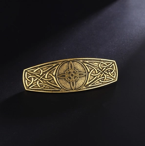 Close-up of vintage golden alloy hair clip with intricate Celtic Knot relief details