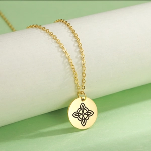 Detailed view of golden Celtic Knot round pendant necklace on a minimalist display