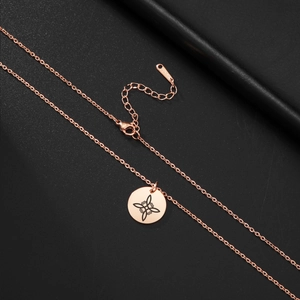 Close-up of rose gold stainless steel necklace with celtic knot pendant and S.STEEL tag