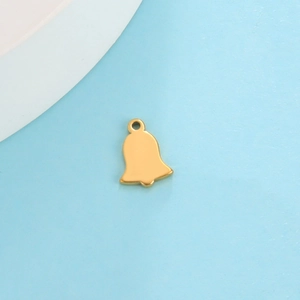 Macro shot of a solid golden bell pendant with smooth finish and top ring for DIY jewelry