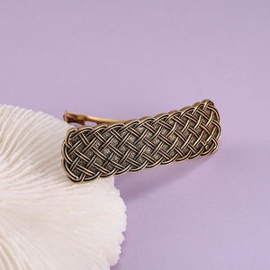 Detailed view of vintage bronze alloy spring hair clip with intricate mesh texture