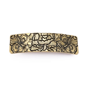 Vintage bronze flower hair clip with detailed floral relief on a white background
