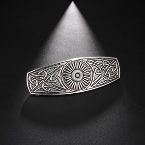 Close-up of vintage alloy hair clip with sunburst motif and Celtic knot details