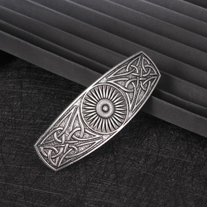 Macro shot of vintage alloy spring hair clip with celtic knot and sun pattern details