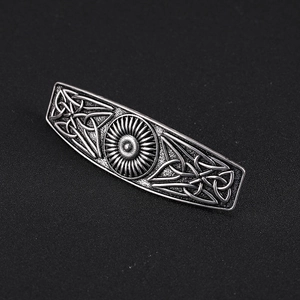 Detail of vintage Celtic knot hair clip in oxidized silver alloy with sun pattern