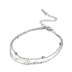 Detailed view of silver double-layer bead chain bracelet with a polished feather pendant