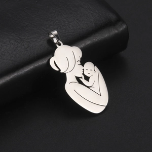 Polished stainless steel mother and baby silhouette pendant on black leather surface
