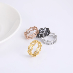 Macro shot of 4-piece vintage stainless steel hollow coin rings set in multi-color finish