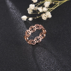 Detail shot of rose gold stainless steel ring with hollowed lucky coin pattern design