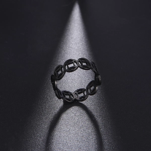 Macro shot of black hollowed-out vintage coin pattern stainless steel ring band