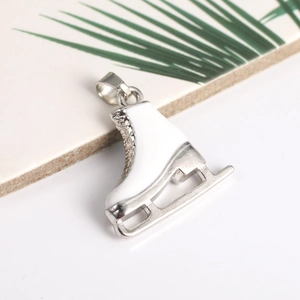Elegant silver ice skate pendant with white enamel and rhinestone details for jewelry making
