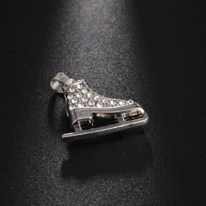 Macro shot of a luxury rhinestone-studded ice skate pendant with polished silver finish