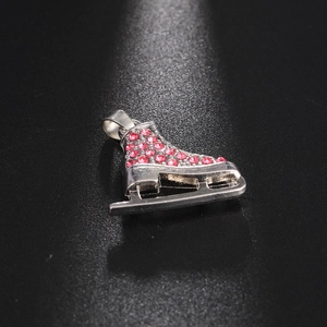 Macro view of pink rhinestone-studded roller skate pendant with silver metal base